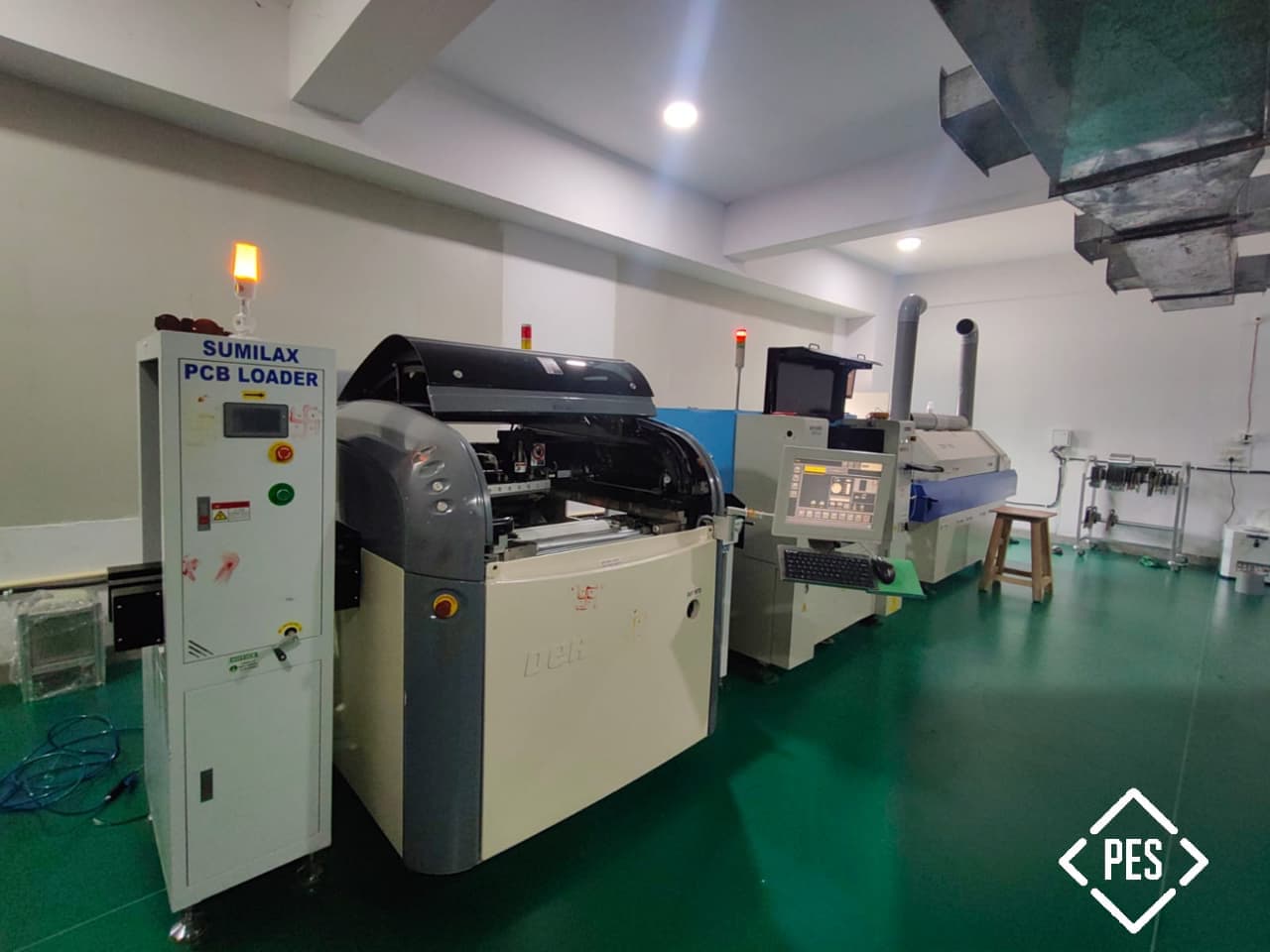 PES Electrical's in-house SMT and PCB assembly line in Faridabad — PCB loader, stencil printer, pick-and-place machine, and reflow oven